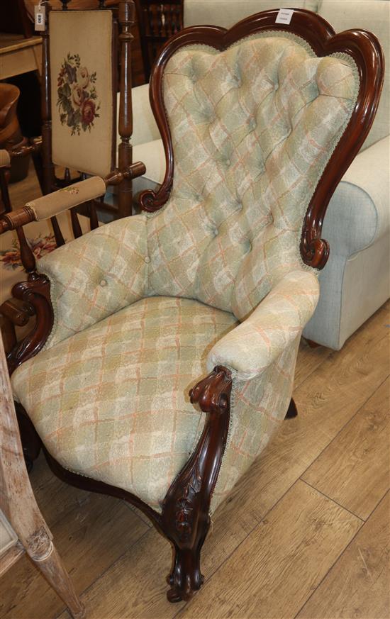 A Victorian carved mahogany framed spoonback buttoned back armchair